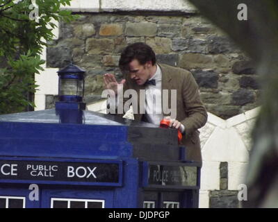 Matt Smith filming a scene for series seven of the popular BBC sci-fi series Dr Who. The Doctor, climbs a ladder and changes a bulb in the lamp on the top of the TARDIS. He proceeds to leave a voice-mail message for Amy Pond and Rory Williams. Wales - 07. Stock Photo