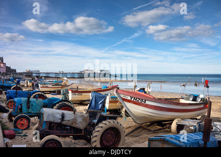 Old tractors get a second career as fishing boat launchers on Cromer Beach, Norfolk, England Stock Photo