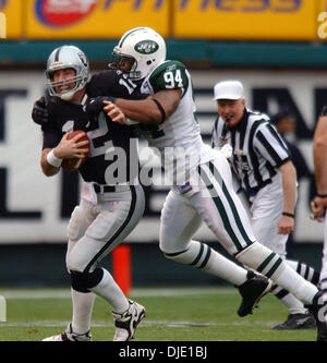 Jan 12, 2003; Oakland, CA, USA; Oakland Raiders quarterback Rich Gannon is sacked byJohn Abraham of the New York Jets in the 1st quarter of their AFC Divisional Playoff game at Network Associates Coliseum Sunday January 12, 2003. Stock Photo
