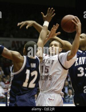 Mar 11, 2004; Dayton, OH; USA; Hawks guard DELONTE WEST (15) is fouled by Brandon Cole (33), right, as he goes to the basket in the 2nd half of the Atlantic 10 Championship Quarterfinal Round between the 27-0 Saint Joseph's Hawks and the Xavier Musketeers in Dayton, Ohio, Thursday, March 11, 2004. Xavier defeated the #1 ranked and undefeated St. Joseph's Hawks 87-67. Stock Photo