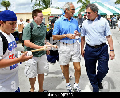 Mar 25, 2004; Palm Beach, FL, USA; Hall of Famer SANDY KOUFAX, (3L), chats with Florida Marlins Owner JEFFREY LORIA, while signing autographs, Thursday March 25, 04, at Roger Dean Stadium. Koufax visited with the Marlins prior to the start of their game against the New York Mets. Stock Photo