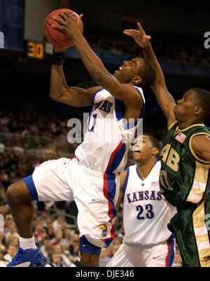 Mar 26, 2004; St. Louis, MO, USA; Kansas'  AARON MILES drives Friday night March 26, 2004 at the Edward Jones Dome in St. Louis, Mo. around UAB's MO FINLEY on his way to the hoop during their Sweet 16 game. Stock Photo