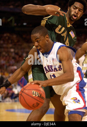 Mar 26, 2004; St. Louis, MO, USA; Kansas' AARON MILES drives Friday night March 26, 2004 at the Edward Jones Dome in St. Louis, Mo. around UAB's GABE KENNEDY during the first half of their Sweet 16 game. Stock Photo