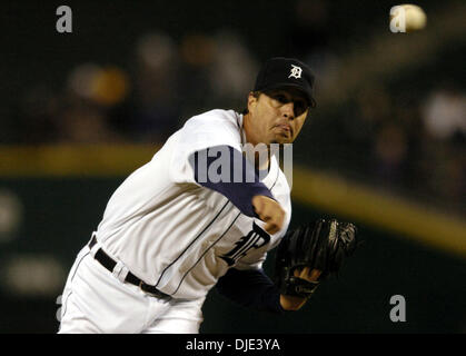 Detroit Tigers pitching coach Bob Cluck, left, takes time to give