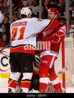 Apr 22, 2004; Detroit, MI, USA; TOMAS HOLSTROM gets checked by Calgary's ANDREW FERENCE in the 2nd period during the Western Conference semi-finals game between the Detroit Red Wings and Calgary Flames at Joe Louis Arena. The Flames beat the Red Wings 2-1. Stock Photo