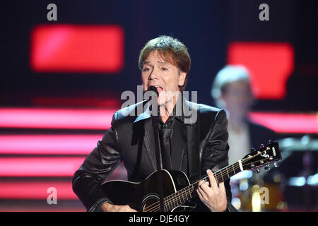 Braunschweig, Germany. 23rd Nov, 2013. Sir Cliff Richard performs during the ZDF show 'Willkommen bei Carmen Nebel' (Welcome at Carmen Nebel) at the Volkswagenhalle in Braunschweig, Germany, 23 November 2013. Photo: Bodo Schackow/dpa - NO WIRE SERVICE / KEIN BILDFUNK -/dpa/Alamy Live News Stock Photo