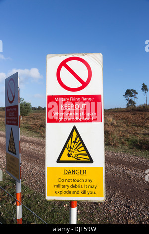 Warning signs on a military firing range at Ash Ranges, Surrey - danger of unexploded bombs and ordnance Stock Photo