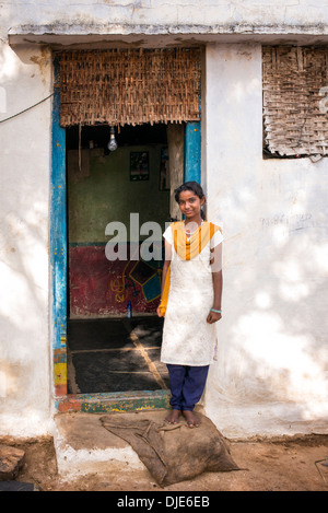 Rural Indian teenage village girl standing in front of her house door. Andhra Pradesh, India Stock Photo