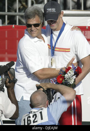 Jul 10, 2004; Long Beach, CA, USA; Former Olympian MARK SPITZ hugs MICHAEL PHELPS after Phelps won the Men's 200 Meter Butterfly at the U.S. Olympic swim trials in Long Beach, California. Stock Photo