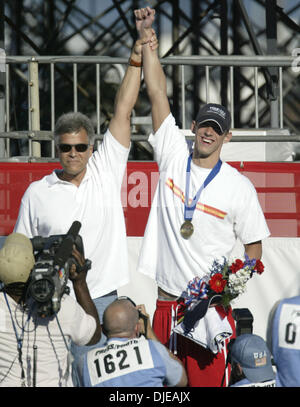 Jul 10, 2004; Long Beach, CA, USA; Former Olympian MARK SPITZ raises the hand of MICHAEL PHELPS after Phelps won the Men's 200 Meter Butterfly at the U.S. Olympic swim trials in Long Beach, California. Stock Photo