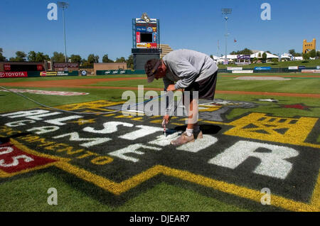 Jul 12, 2004; Sacramento, CA, USA; LEDE-- Raley Field groundskeeper Brian Johnson (cq) touches up  the colors on an 'All Star Game' logo on the field near home plate at Raley Field in West Sacramento on Tuesday July 12, 2005. Raley Field prepares to host the All-Star game tomorrow. Stock Photo