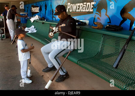 Jul 12, 2004; Sacramento, CA, USA;ELIJAH YOUNG  4 watches his father International League Buffalo Bisons outfielder ERNIE YOUNG tape up his bat befor batting practice at Raley Field in West Sacramento on Tuesday July 12, 2005. Raley Field prepares to host the All-Star game tomorrow. Stock Photo