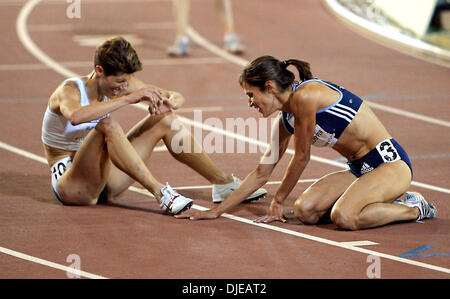 Jul 12, 2004; Sacramento, CA, USA; SHAYNE CULPEPPER (R) sits on the ground with a grimacing MARLA RUNYAN (L) in the womens 5000 meter on day four of the 2004 U.S. Track and Field Trials at Hornet Stadium. Stock Photo