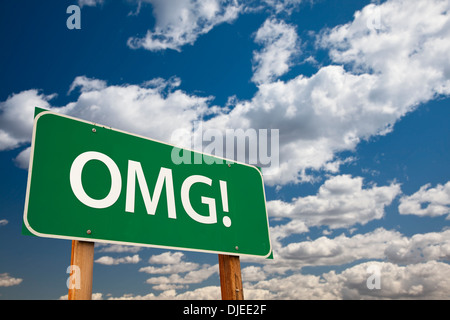 OMG!, Texting Abbreviation for Oh My Gosh, Green Road Sign with Dramatic Sky and Clouds. Stock Photo