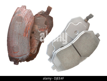 Old and new brake pads compared side by side and silhouetted. Stock Photo