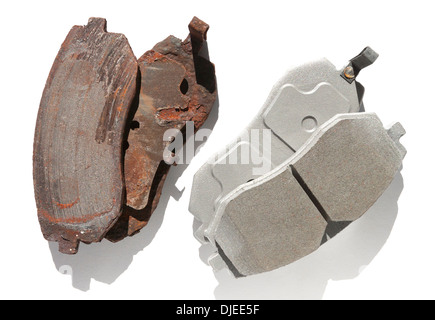 Old and new brake pads compared side by side and silhouetted. Stock Photo