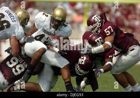 Oct 23, 2004; College Station, TX, USA; NCAA College Foootball - Colorado running back Bobby Purify (42) is brought down by the Texas A&M after a first-half gain in College Station on Saturday, Oct. 23, 2004. Texas A&M is ranked 17th in the nation. Stock Photo