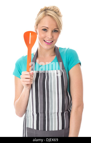 Model Released. Attractive Young Woman Holding a Slotted Serving Spoon Stock Photo