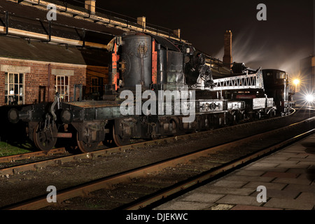 Great Western Railway (GWR) 5700 Class 0-6-0PT preserved pannier tank steam locomotive on a breakdown train at night Stock Photo