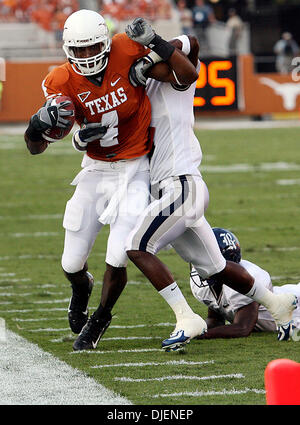 Sep 22, 2007 - Austin, TX, USA - NCAA Football: Texas Longhorns #4 Limas Sweed stays in bounce as Rice defender hangs on in the 1st quarter of play at Darrall Royal Texas Memorial Stadium. The Texas Longhorns beat Rice 58-14. (Credit Image: © Delcia Lopez/San Antonio Express-News/ZUMA Press) RESTRICTIONS: US Tabloid Sales OUT! SAN ANTONIO and SEATTLE NEWS PAPERS OUT! Stock Photo