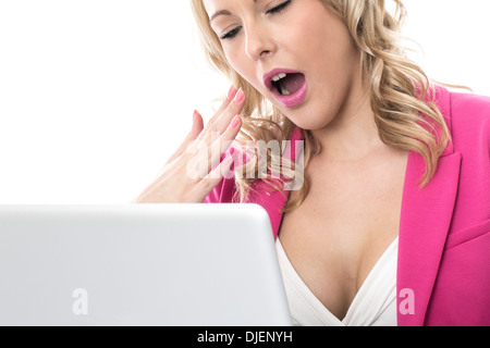 Model Released. Attractive Bored Young Business Woman Using a Laptop Computer Stock Photo