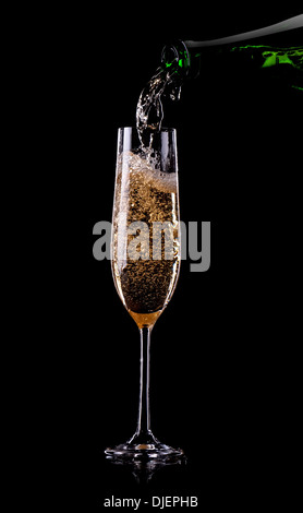 Golden champagne pouring in glass from a bottle Stock Photo