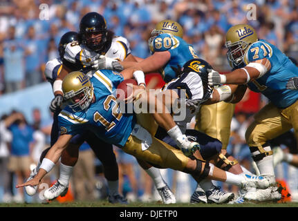 October 20th 2007 - Pasadena, CA, USA - UCLA quarterback Patrick Cowan, #12, gets tripped by California Golden Bear's Zack Follett, #56, in the 1st quarter of their game on Saturday, October 20, 2007 at the Rose Bowl in Pasadena, Calif. (Credit Image: © Jose Carlos Fajardo/Contra Costa Times/ZUMA Press) Stock Photo