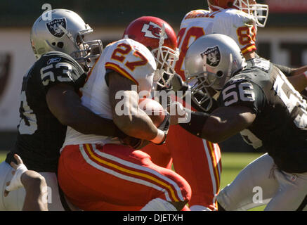 Oct 21, 2007 - OAKLAND, CA, USA - Oakland Raiders linebacker THOMAS HOWARD #53 and defensive end DERRICK BURGESS #56 tackle Kansas City Chiefs running back LARRY JOHNSON #27 during their game at McAfee Coliseum. (Credit Image: © Al Golub/ZUMApress.com) Stock Photo