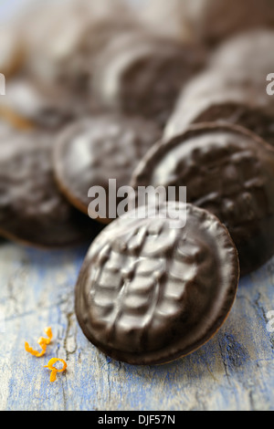 Jaffa cakes with orange garnishes on a blue wooden table Stock Photo