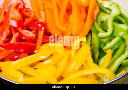 A bowl of colorful pepper slices ready to process Stock Photo