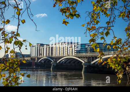 Chelsea Bridge Wharf Apartments and Railway Bridge River Thames London. The railway bridge is the rail route to Victoria Station Stock Photo