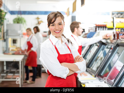 Confident Female Butcher Standing Arms Crossed Stock Photo