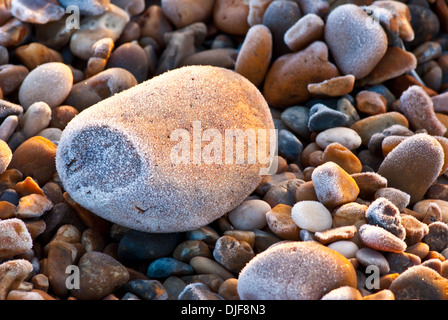 Frosted pebbles on a beach Stock Photo