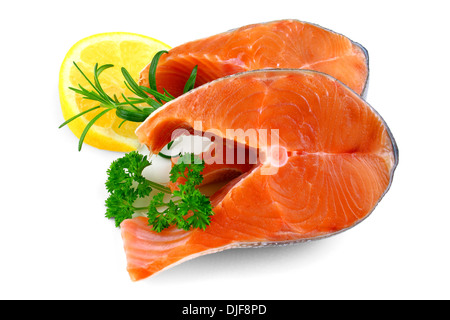 Two salmon steaks with lemon and herb, isolated Stock Photo
