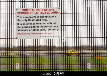 Signs on security fencing at Manchester Airport, UK. Stock Photo
