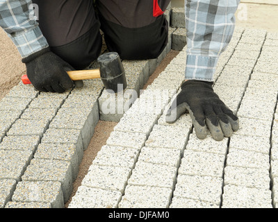 Paver laying pathway out of concrete pavement blocks Stock Photo