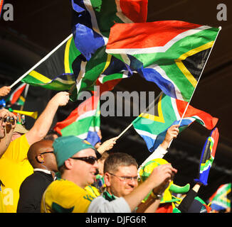 June 11, 2010 - Johannesburg, GAUTENG, SOUTH AFRICA - Fans wave South African flags during the first game of the 2010 FIFA World Cup which had host nation South Africa playing Mexico to a 1-1 draw Friday, June 11, 2010 at Soccer City in Johannesburg, South Africa. Photo by Bahram Mark Sobhani (Credit Image: © Mark Sobhani/ZUMApress.com) Stock Photo