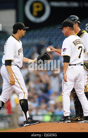 July 20, 2010 - Pittsburgh, PA, United States of America - 20 July 2010: Pittsburgh Pirates' Manager John Russell (7) turns the ball over to Pittsburgh Pirates' relief pitcher D.J. Carrasco (77) after pulling Pittsburgh Pirates' starting pitcher Brad Lincoln (32) in the third inning of game action between the Pirates and Brewers at PNC Park in Pittsburgh, PA...Pirates beat the Brew Stock Photo