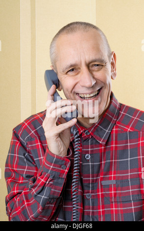 Happy man laughing and speaking with a friend on phone Stock Photo