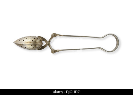 An antique tea strainer in silver metal Stock Photo