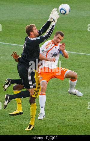 July 24, 2010 - Columbus, Ohio, United States of America - 24 July 2010:  Crew goalkeeper William Hesmer (1) leaps over Dynamo forward Cam Weaver (15) and Crew defender Shaun Francis (29) to save a Dynamo shot on goal during first-half match action.  The Columbus Crew defeated the Houston Dynamo 3-0 at Crew Stadium in Columbus, Ohio.   .Mandatory Credit: Scott W. Grau / Southcreek  Stock Photo