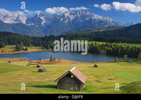 The Karwendel Mountain Range and huts along lake Gerold / Geroldsee near Mittenwald, Upper Bavaria, Germany Stock Photo