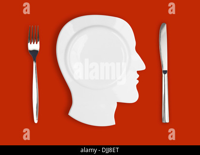 Knife, head plate and fork on red background Stock Photo