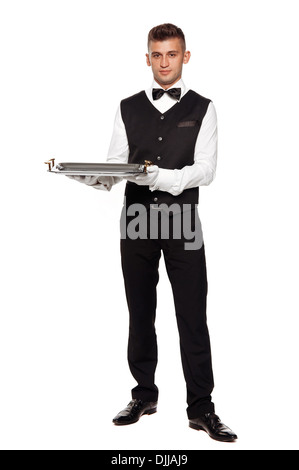 A young boy waiter with a tray. Isolated background and clipping path Stock Photo