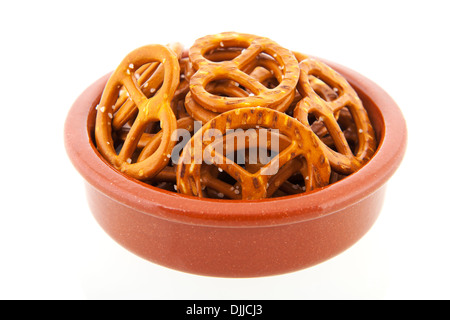 German pretzels in brown bowl isolated over white background Stock Photo