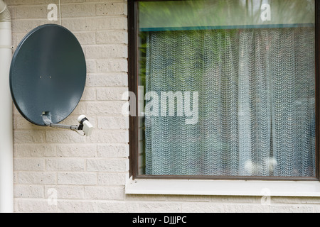 Satellite is attached to the brick wall of the house, horizon format Stock Photo