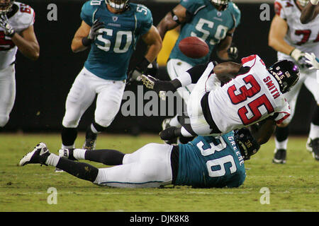 Sep. 02, 2010 - Jacksonville, Florida, United States of America - Atlanta Falcons running back Antone Smith (#35) fumbles after being hit by Jacksonville Jaguars Courtney Greene (#36) early in the game against the Jacksonville Jaguars. The Jaguars are leading the Falcons 10-6 at halftime in the game at Everbank Field in Jacksonville, Fl. (Credit Image: © David Roseblum/Southcreek G Stock Photo