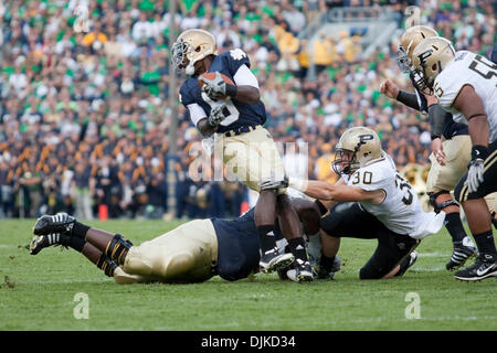 Sep. 04, 2010 - South Bend, Indiana, United States of America - Notre Dame wide receiver Theo Riddick (#6) is tackled by Purdue linebacker Joe Holland (#30) in game action during NCAA football game between the Notre Dame Fighting Irish and the Purdue Boilermakers.  Notre Dame defeated Purdue 23-12 in game at Notre Dame Stadium in South Bend, Indiana. (Credit Image: © John Mersits/S Stock Photo