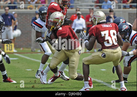 Sept. 7, 2010 - Jacksonville, Florida, United States of America - January 4, 2010: FSU Safety Terrance Parks (4) recovers a blocked punt and returns the ball inside the Samford 10 yard line to set up a TD for FSU while Toshmon Stevebns (96) and Jermaine Thomas (38) block.  FSU defeated Samford 59-6 at Doak Campbell Stadium in Tallahassee, Florida. (Credit Image: © Mike Olivella/Sou Stock Photo