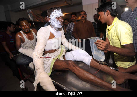 Dhaka, Bangladesh. 28th Nov, 2013. An injured person receives medical treatment at a hospital after miscreants set fire on a passenger bus during the countrywide transport blockade in Dhaka, Bangladesh, Nov. 28, 2013. Anti-government protestors took to the streets and fought pitched battles with law enforcers in many Bangladesh districts, as the main opposition alliance for the third consecutive day enforced nationwide blockade which triggered wide spread violence, claiming 18 lives. Credit:  Xinhua/Alamy Live News Stock Photo
